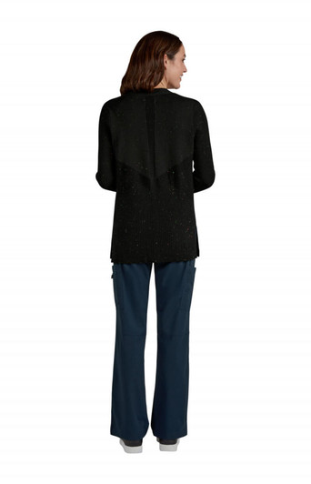 A black Kori Sweater being worn from the back, paired with navy blue trousers. The garment features a textured design and has a logo.