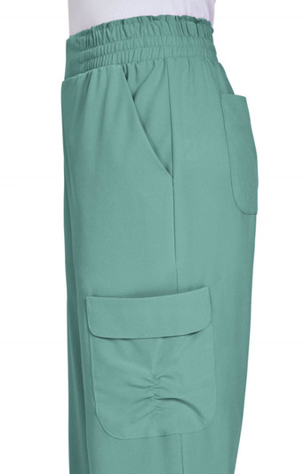 Ayla Pant in a soft green colour features an elastic waistband and side pockets. The product has a branding logo.
