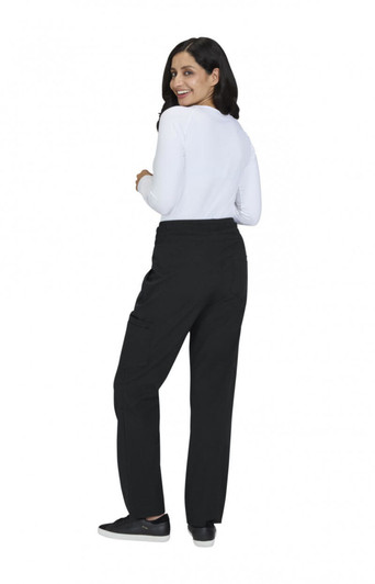 A woman wearing black wide-leg pants and a white long-sleeve top, facing away from the camera.