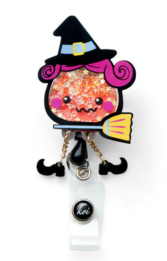 A colourful badge featuring a whimsical witch character with pink hair, a broom, and sparkling details, attached to a clip.