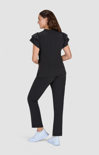 A black top with ruffle sleeves paired with black pants, modelled from the back, featuring light blue footwear.