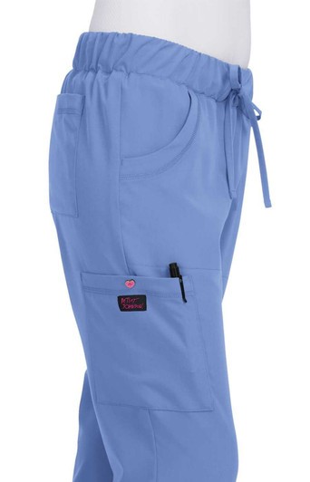 A pair of light blue pants with an elastic waistband and pockets, featuring a logo on the pocket.