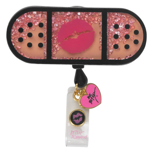 A retractable badge holder featuring a pink glitter design with a kiss motif and decorative charms in black and pink.