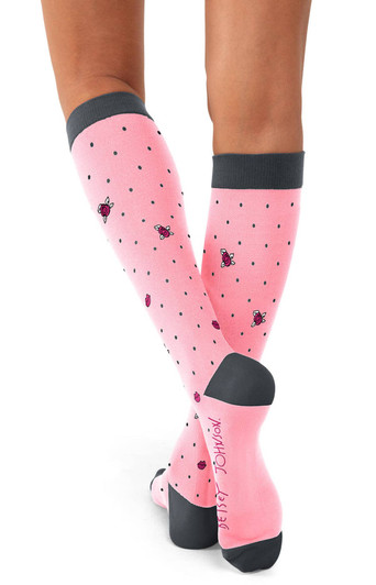 A pair of pink compression socks with polka dots and a logo, featuring a grey cuff and sole.