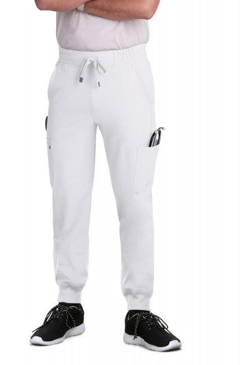 A pair of white jogger pants with pockets, styled with a casual top and black footwear.