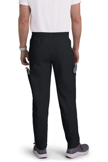 A pair of black cargo pants viewed from the back, featuring pockets and an elastic waistband.