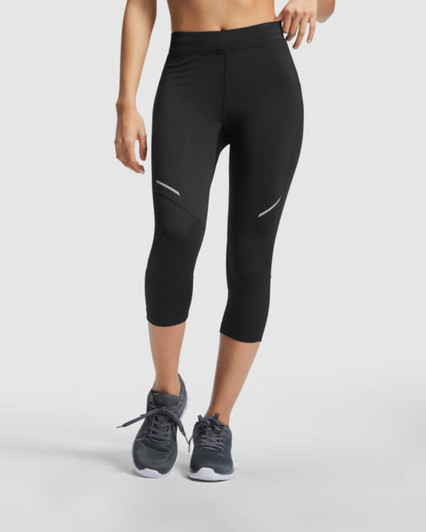 Black mid-length leggings featuring reflective accents, paired with grey athletic shoes. The leggings have a sleek, fitted design.