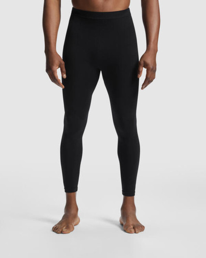 A pair of black leggings designed for men, featured on a model standing barefoot. The product has a logo detail.