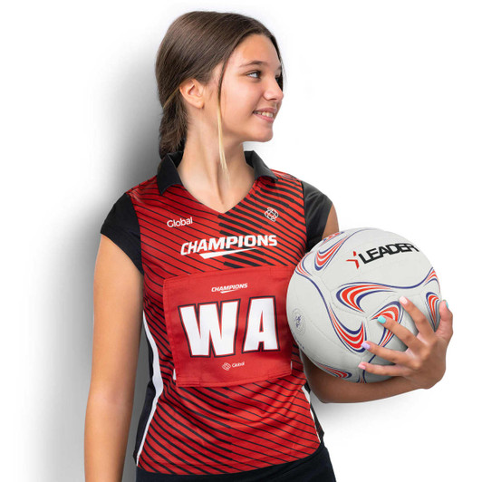 A custom women's netball bib in red and black, featuring a logo, held by a model alongside a netball.