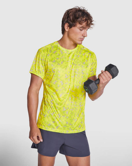 A bright yellow Assen T-Shirt made from a lightweight material, worn by a man holding a dumbbell.