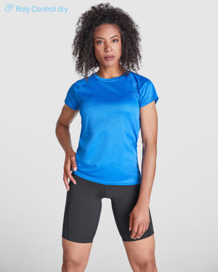A blue women's T-shirt made from moisture-wicking fabric, paired with black shorts, featuring a logo.