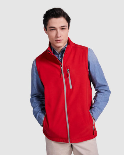 A red vest with a zippered front and pockets, worn over a blue shirt. It features a logo on the chest.