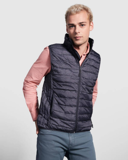 A dark navy padded vest with a high collar, worn over a light pink shirt, featuring a logo.