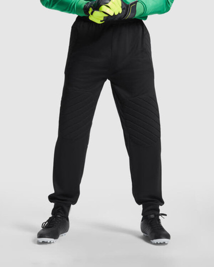 Black Bayern goalkeeper trousers with a quilted design and elastic waistband, paired with gloves and shoes.