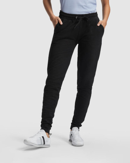 Black women's track pants with a fitted design, featuring pockets and an elasticised waistband.