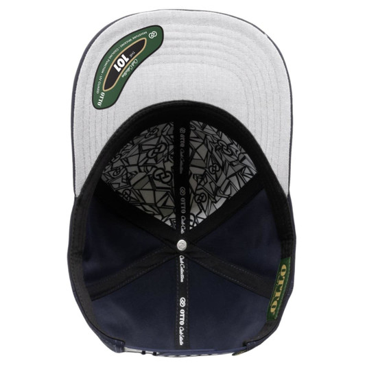 A navy blue six-panel cap with a grey peak and an interior featuring a detailed pattern and a logo.
