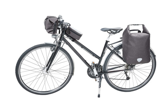 A black bicycle with a handlebar bag and two side bags, all in dark fabric. The bike has a sleek design.