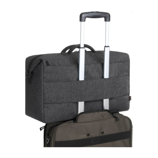 A grey duffle bag with a retractable handle, resting on top of a black suitcase. Features branding.