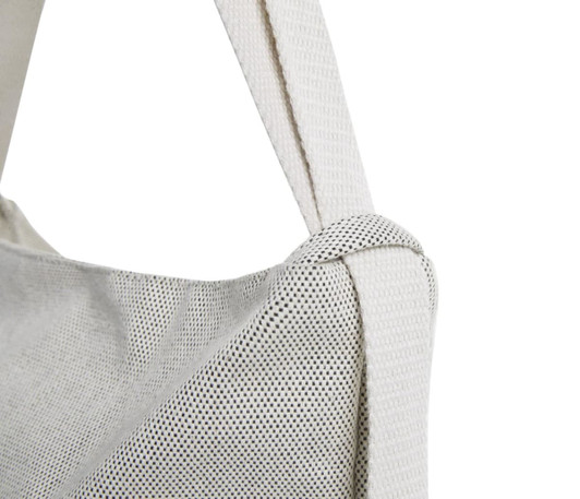 A multi-purpose bag in white with a textured surface and a sturdy strap, featuring a logo.