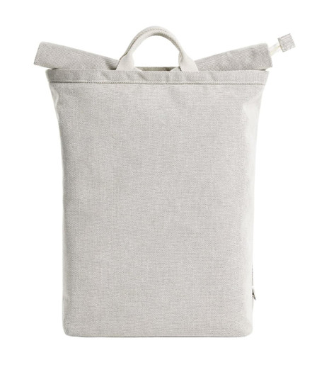 A grey Loom Backpack with a minimalist design and a top handle. It features a logo on the front.