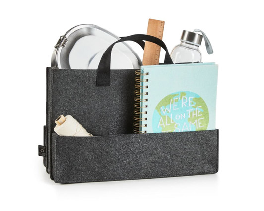 A grey felt bag with a handle containing a drink bottle, notebook, container, ruler, and string.