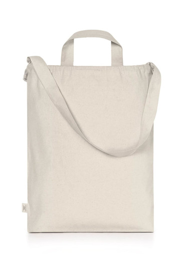 A light cream organic drawstring tote bag with two handles and a shoulder strap. Minimal branding is present.