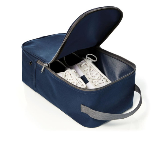 A navy shoe bag with a zippered closure, featuring a handle and storing a pair of white shoes inside.