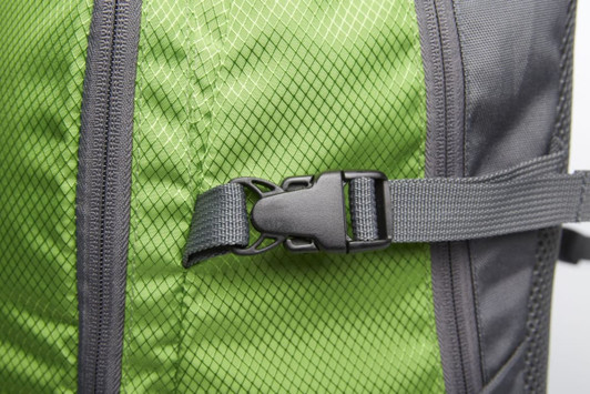 A green and grey backpack featuring a mesh design and adjustable buckle. It has a branded logo on the side.