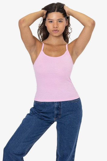 A pink baby rib spaghetti tank top worn by a model, featuring a fitted design and thin straps.
