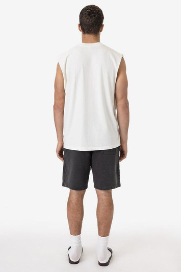 A sleeveless white tee is displayed on a model, paired with grey shorts and white socks. There is a logo on the shirt.