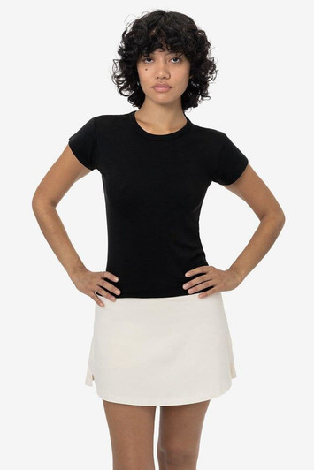 A black cap sleeve baby tee paired with a light-coloured skirt, displayed on a model. The tee has a logo.