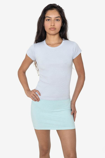 A model wearing a light blue cap sleeve baby tee paired with a mint green mini skirt. The shirt features a logo.