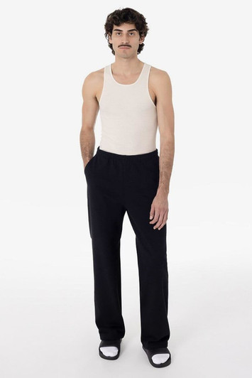 A model wearing straight leg heavy fleece pants in black, paired with a light tank top and sneakers.