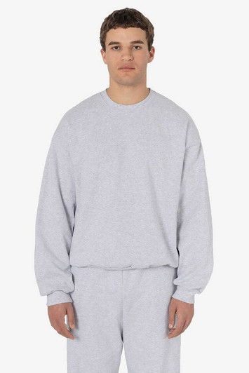 A grey heavy fleece pullover with long sleeves, displayed on a model. The product has a logo.