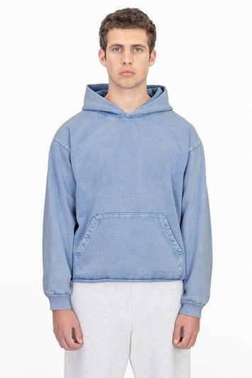 A blue mineral wash hooded pullover with a front pocket and a logo, worn by a model.
