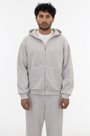 A grey heavy fleece zip-up hoodie with a front zipper and hood, modelled by a person.