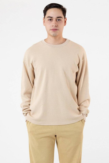 A light beige garment dye heavy thermal crewneck sweater, displayed on a model with relaxed fit pants.