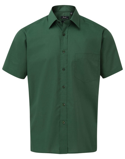 A short-sleeved button-up shirt in a deep green colour with a single chest pocket. Features a logo.