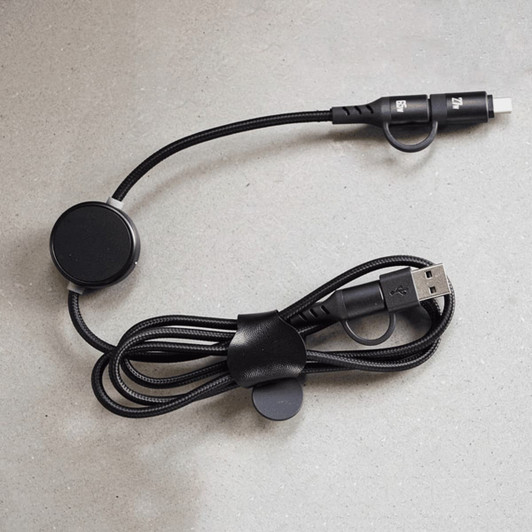 A black charging data cable with a unique design, featuring a circular attachment and a sturdy braided cord.