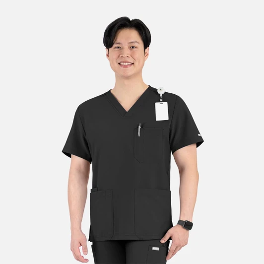 A black V-neck top with four pockets, featuring a logo and a lanyard clip, worn by a smiling man.