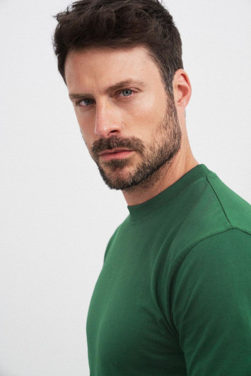 A green Round-T Heavy t-shirt displayed on a model, showcasing a fitted style and crew neck design.