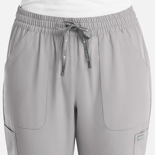 A pair of women's full elastic pull-on pants in light grey, featuring pockets and a drawstring waist.