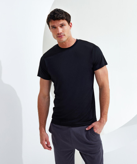 A black performance t-shirt displayed on a male model against a minimalist backdrop, showcasing its fit and style.