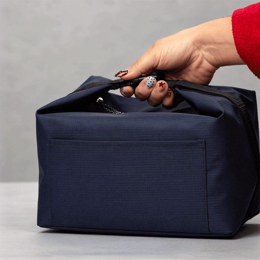 A navy blue cooler bag with a handle, featuring a zipped top and a side pocket.