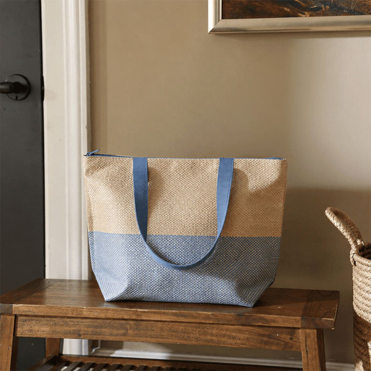 A large zipped tote bag in a natural and blue colour scheme, featuring sturdy handles and a spacious design.