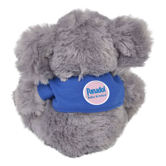 A plush koala toy in grey, wearing a blue shirt with a logo, featuring fluffy fur and rounded ears.