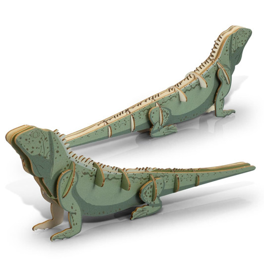 A green and natural wooden model of a tuatara, featuring intricate cut-out details and a creative design.