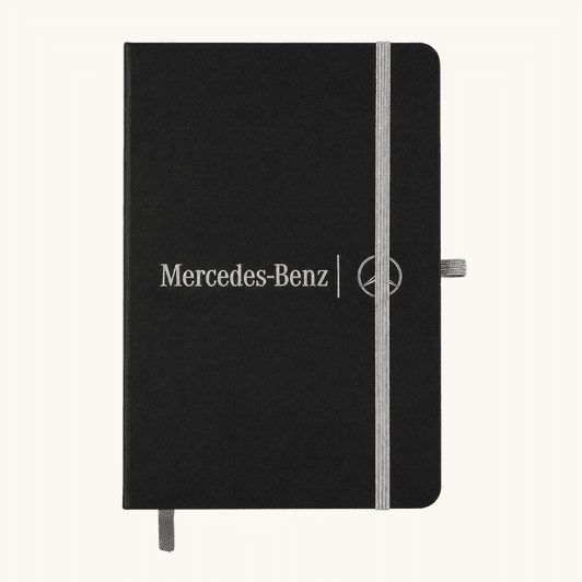 A black A5 notebook with an elastic closure and a logo on the front, featuring a grey band and bookmark.
