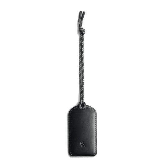 A black luggage tag made of leather, featuring a braided attachment. It has a logo on its surface.