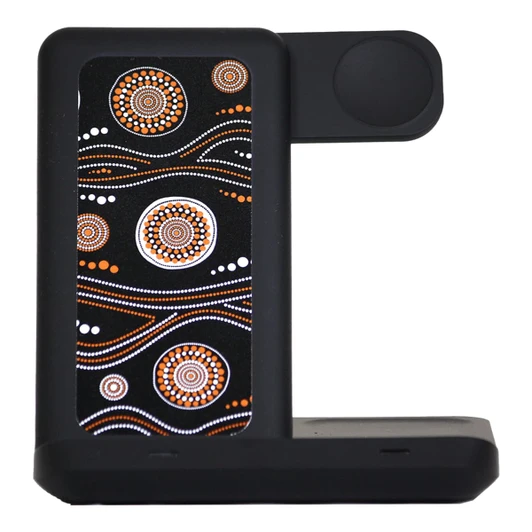 A wireless charger featuring a black base with an intricate orange and white Aboriginal-inspired design.